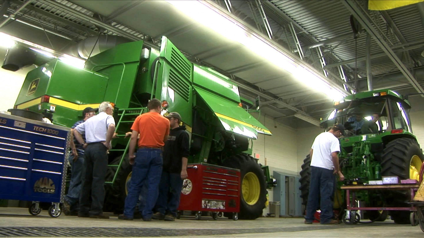 Students examining tractors