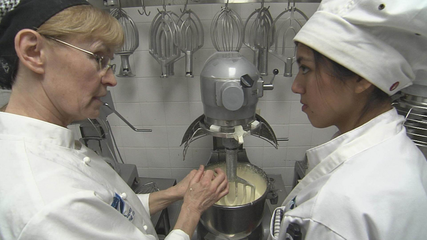 instructor and student mixing dough