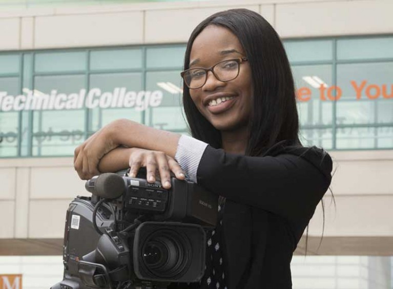 Woman smiling with film equipment