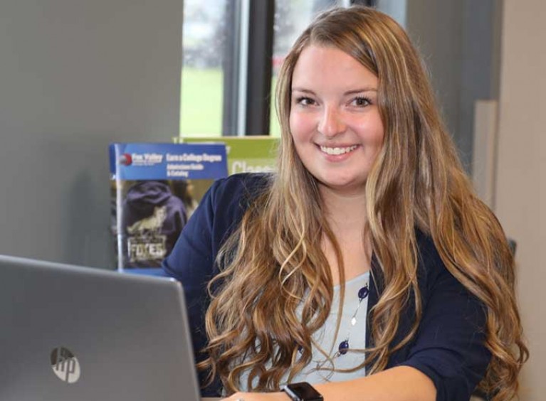 Woman working on laptop smiling