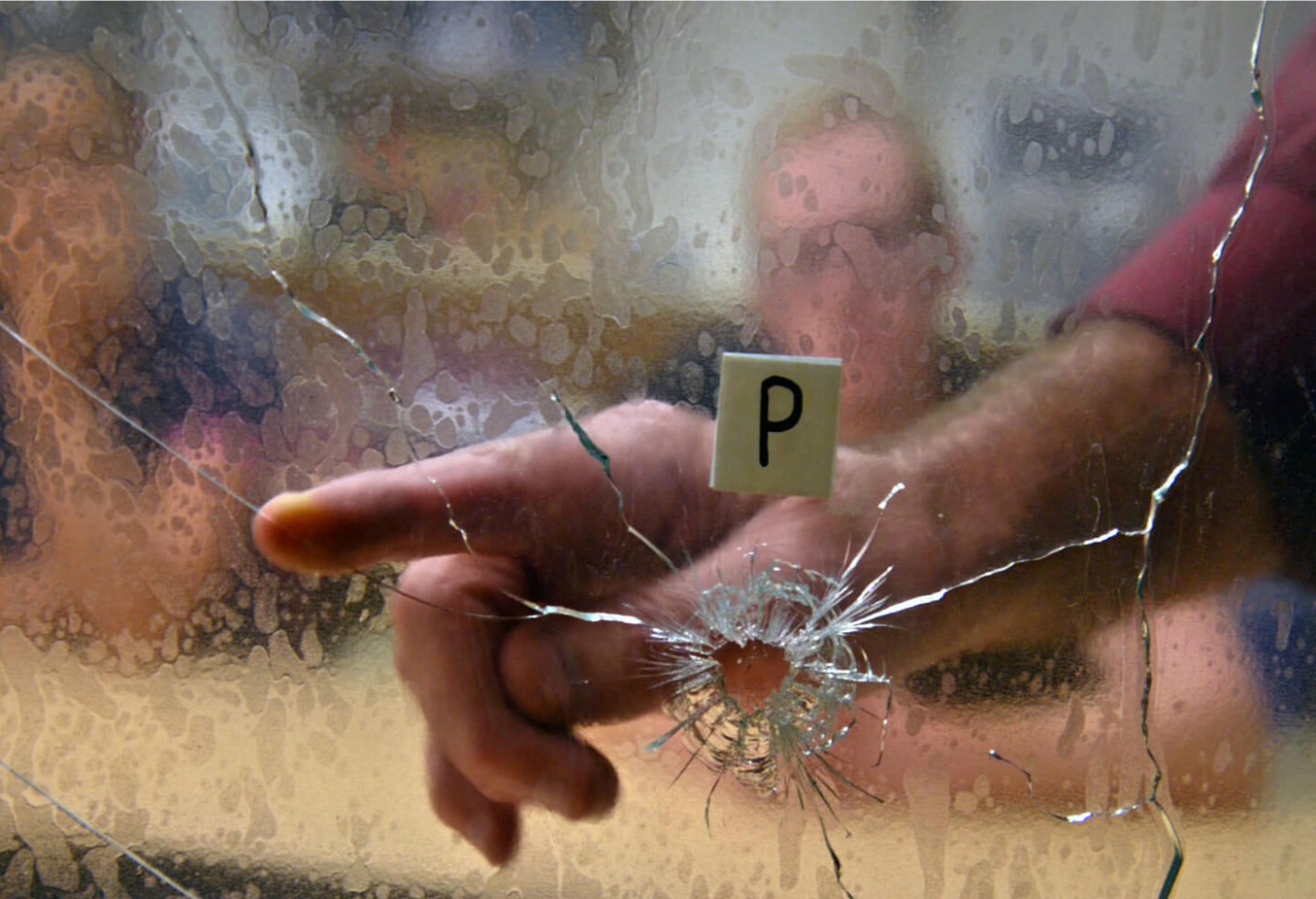 Evidence Technician examining broken glass