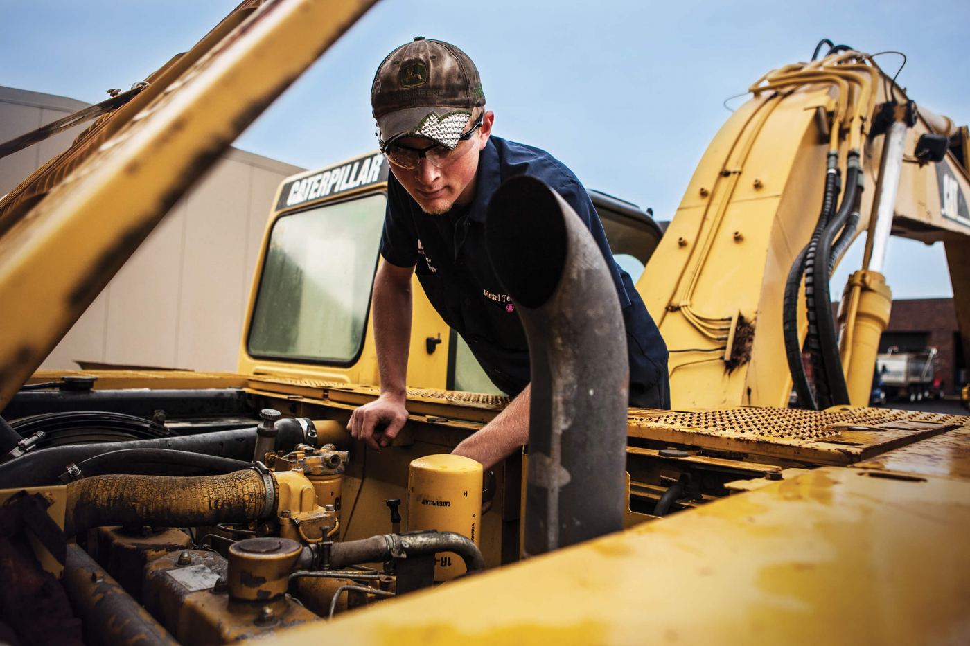 Diesel repairman looking over engine