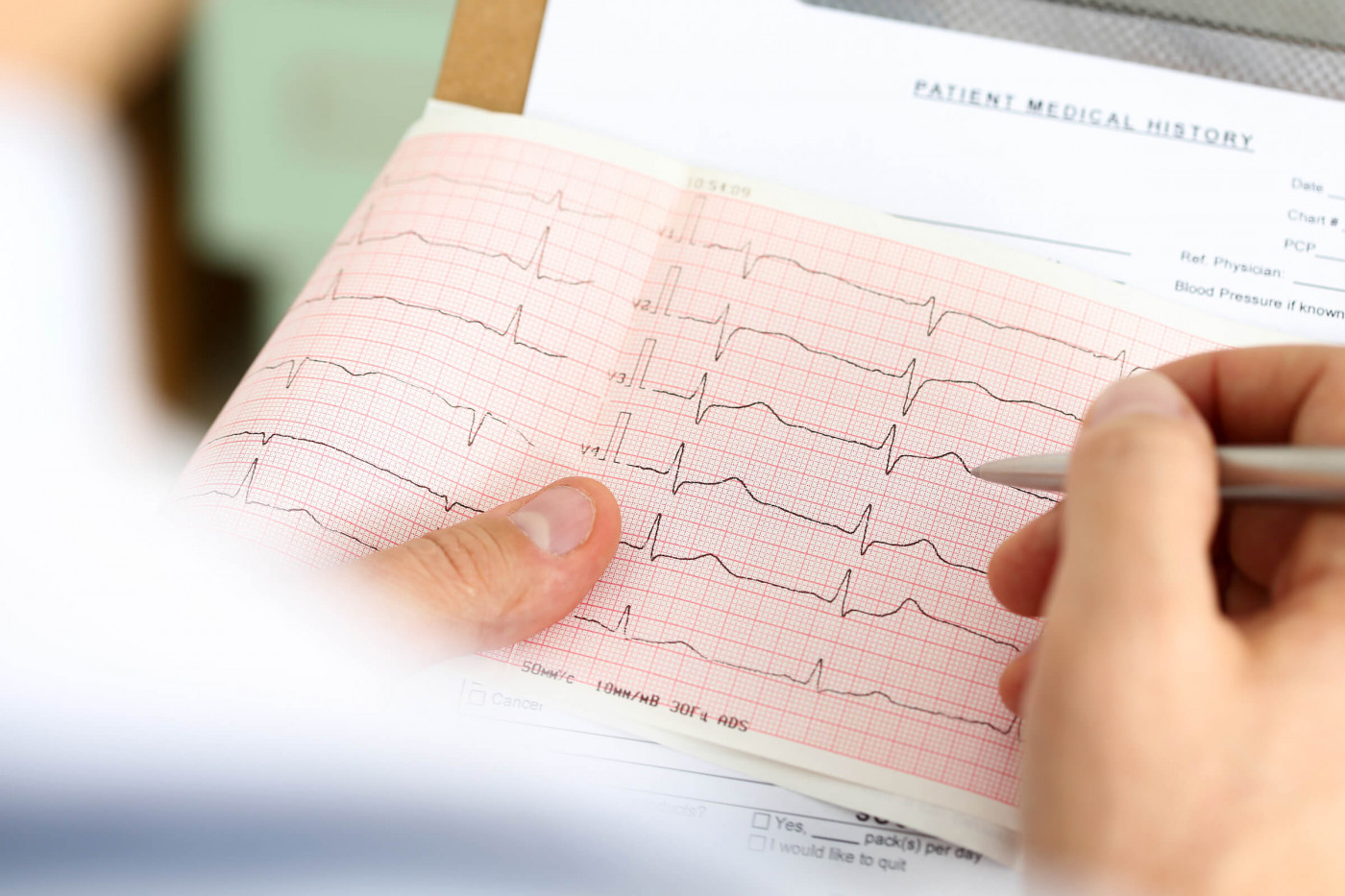 Technician reading an EKG report 