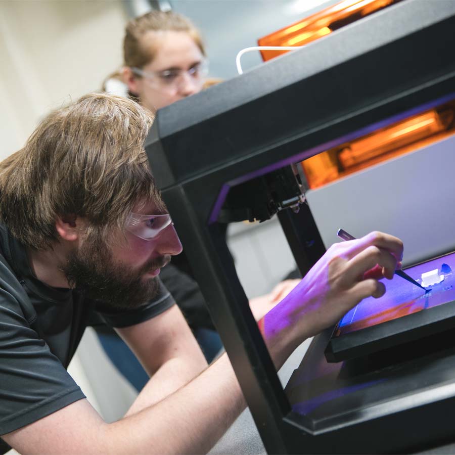 Student working with 3D printer