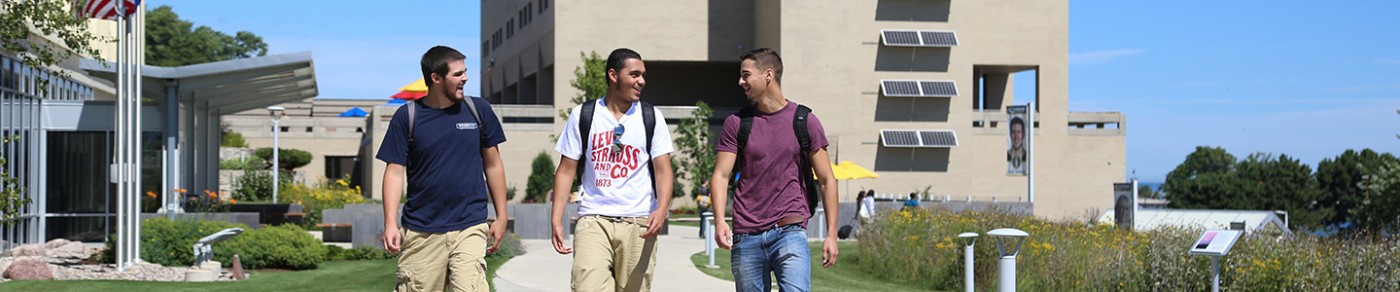 Three students walking on campus