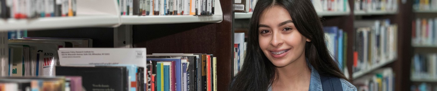 Student smiling in library