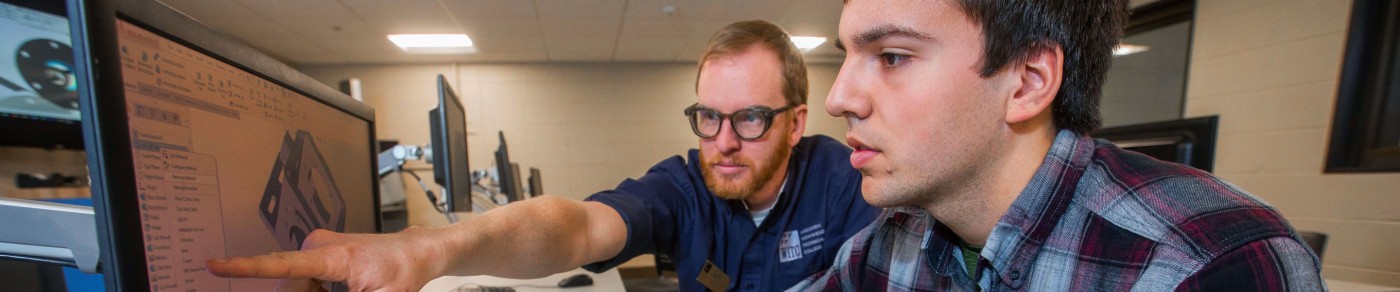 Student and instructor working on computer