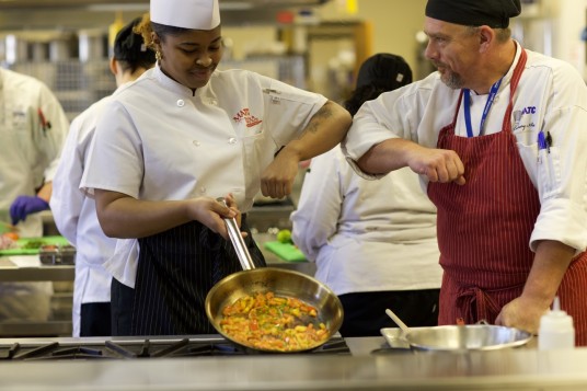 Instructor Congratulating a Culinary Student