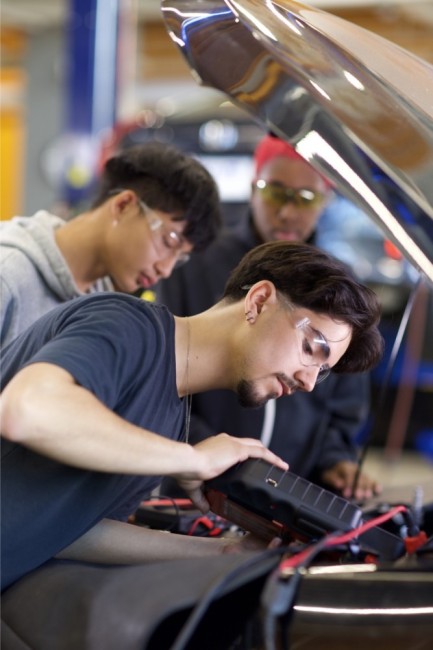 Students Looking Under a Hood of a Car