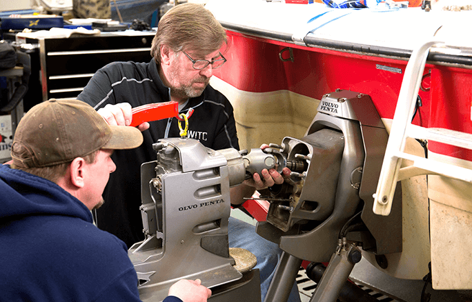 Instructor and student in marine repair program