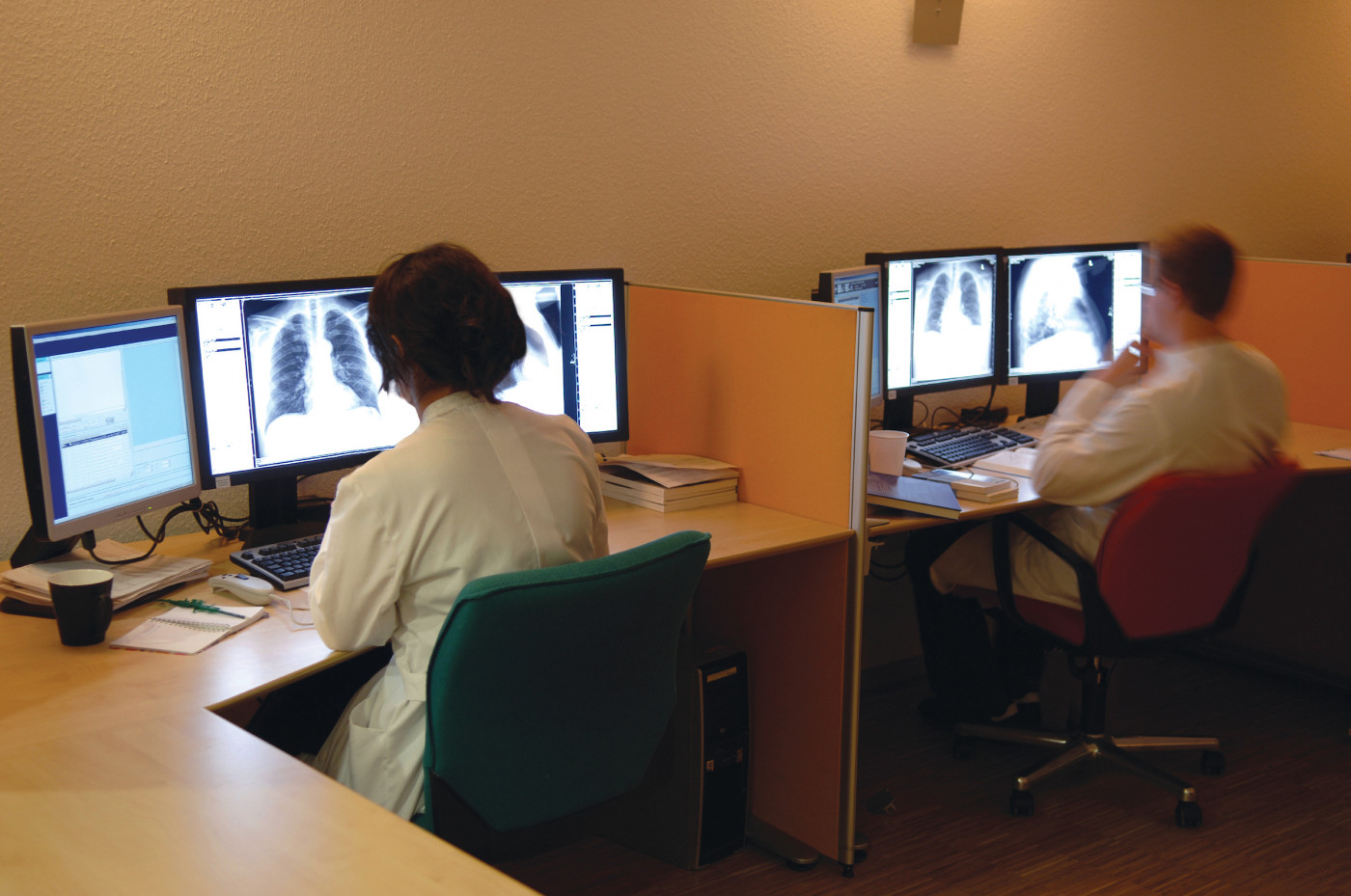 Respiratory therapists examining chest x-rays