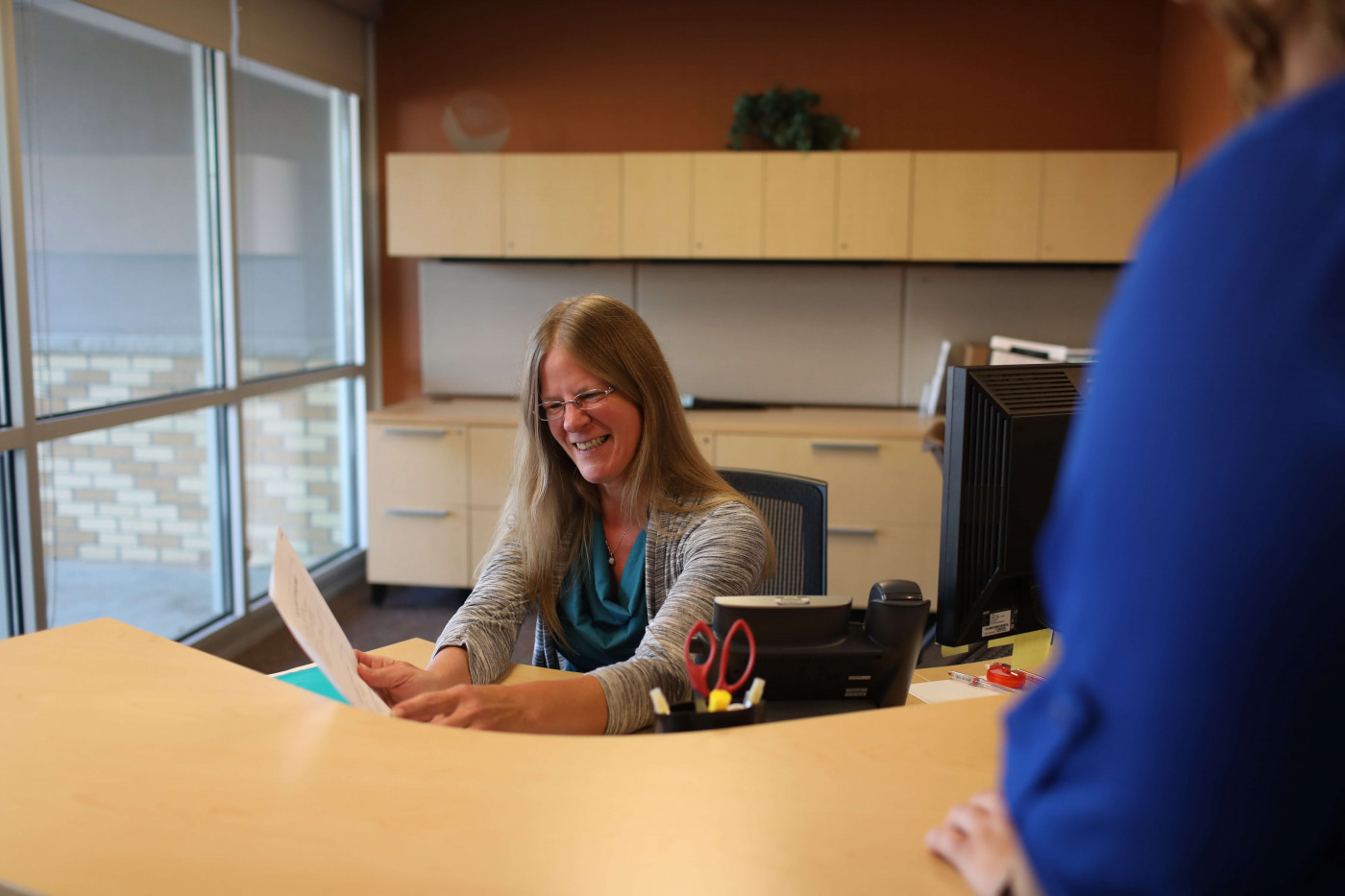 Medical Administrative Specialist talking with a colleague