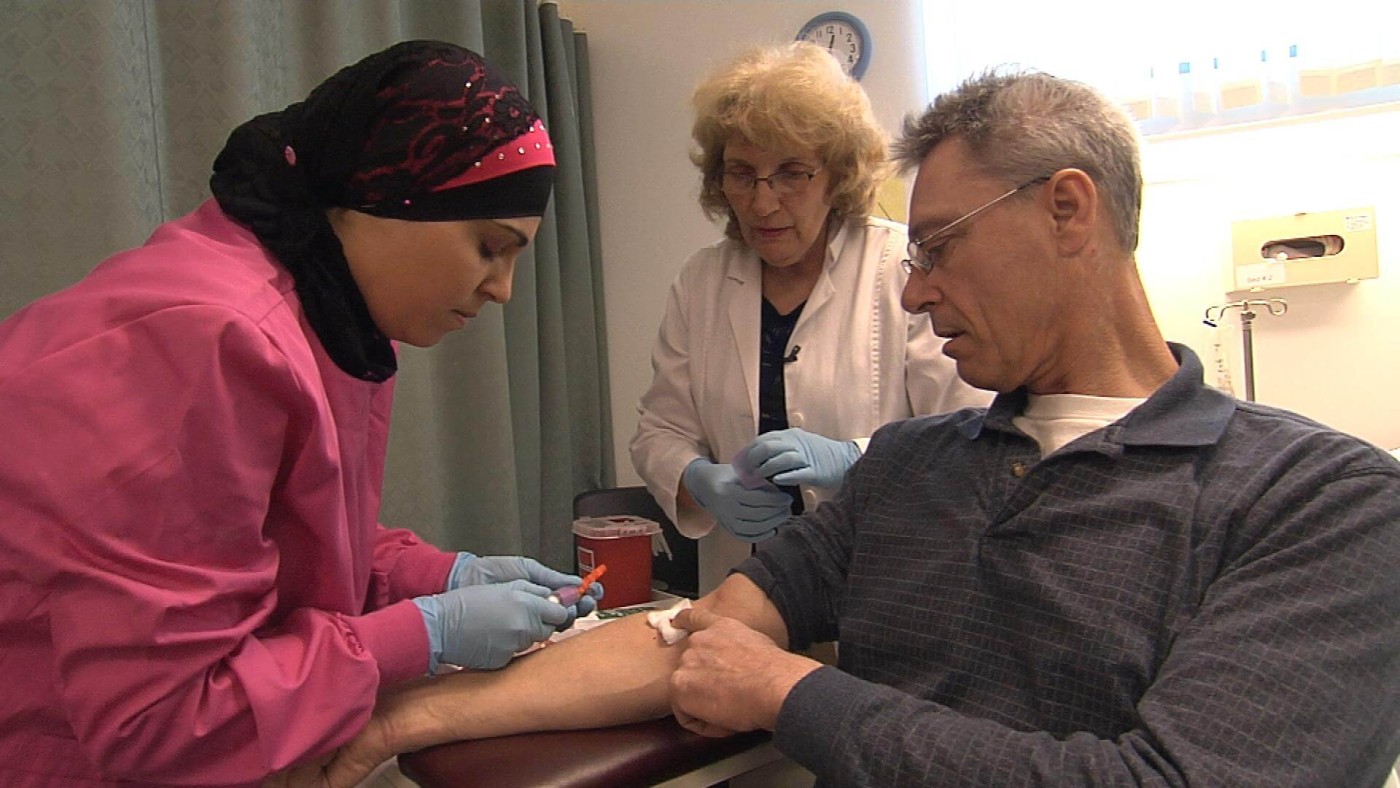 Phlebotomy Tech is drawing blood from a patient