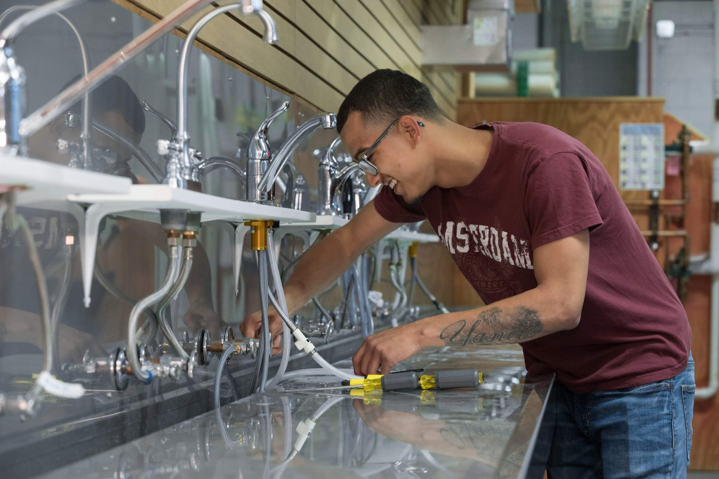 Preparatory Plumbing student working on faucets