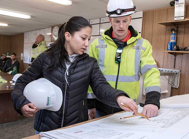 Architect discussing plans with construction worker