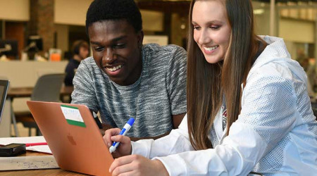 Two students studying together on campus