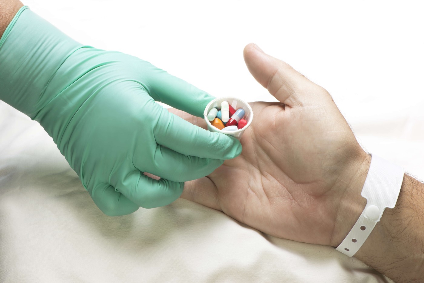 Medication Assistant handing medicine to patient