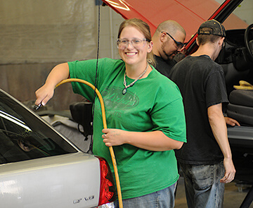 Student learning auto mechanics