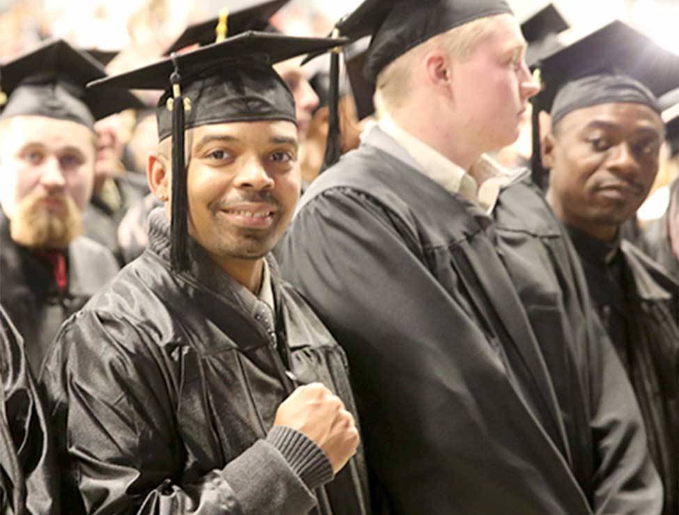 Graduate smiling at graduation ceremony