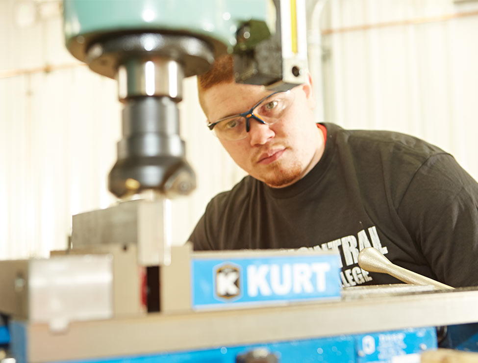 Student working with machine on campus