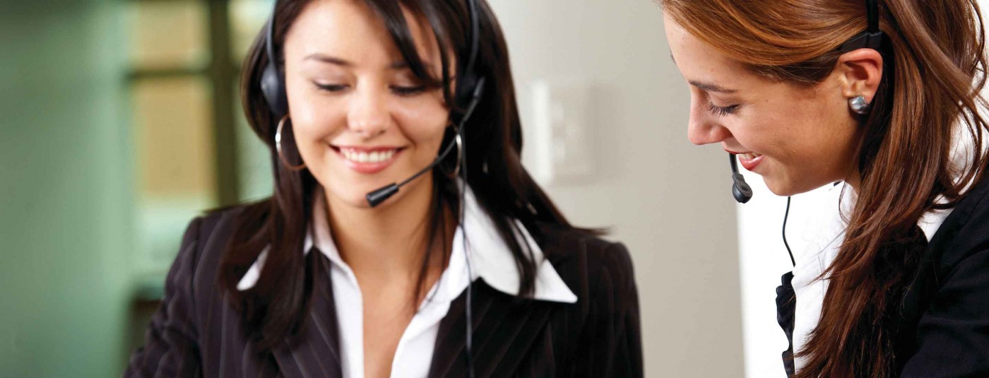 Two women with microphone headsets