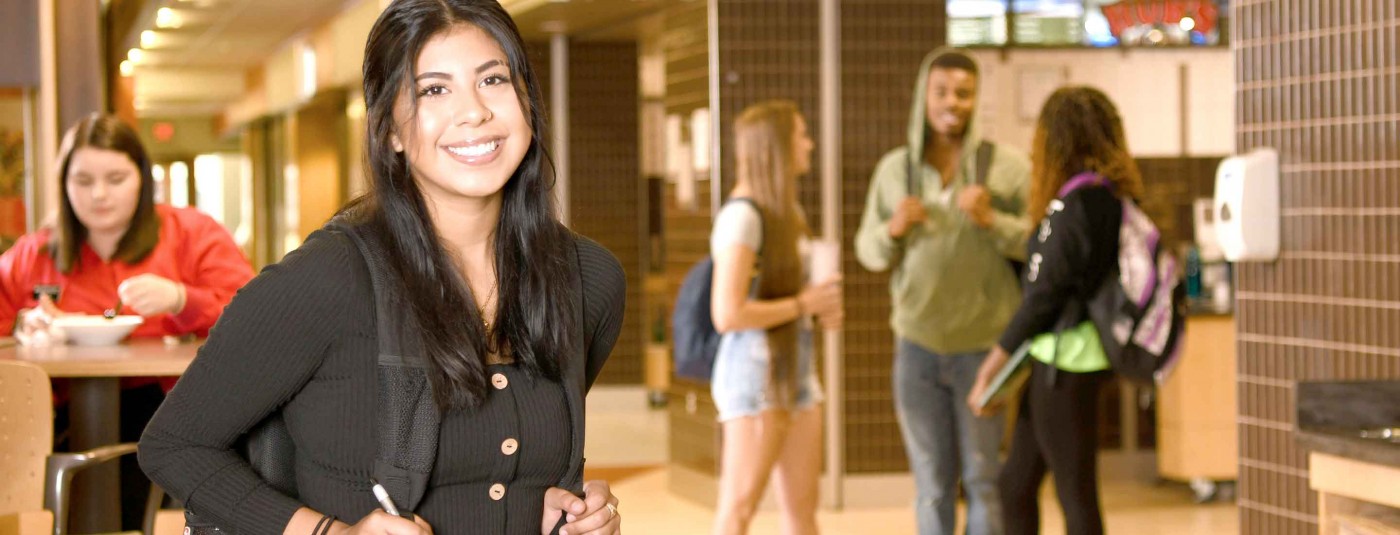 Student smiling in school hallway