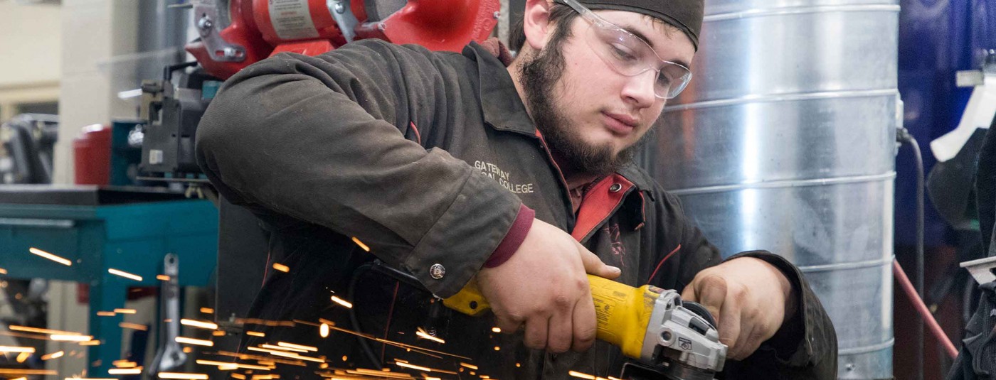 student using power grinding tools