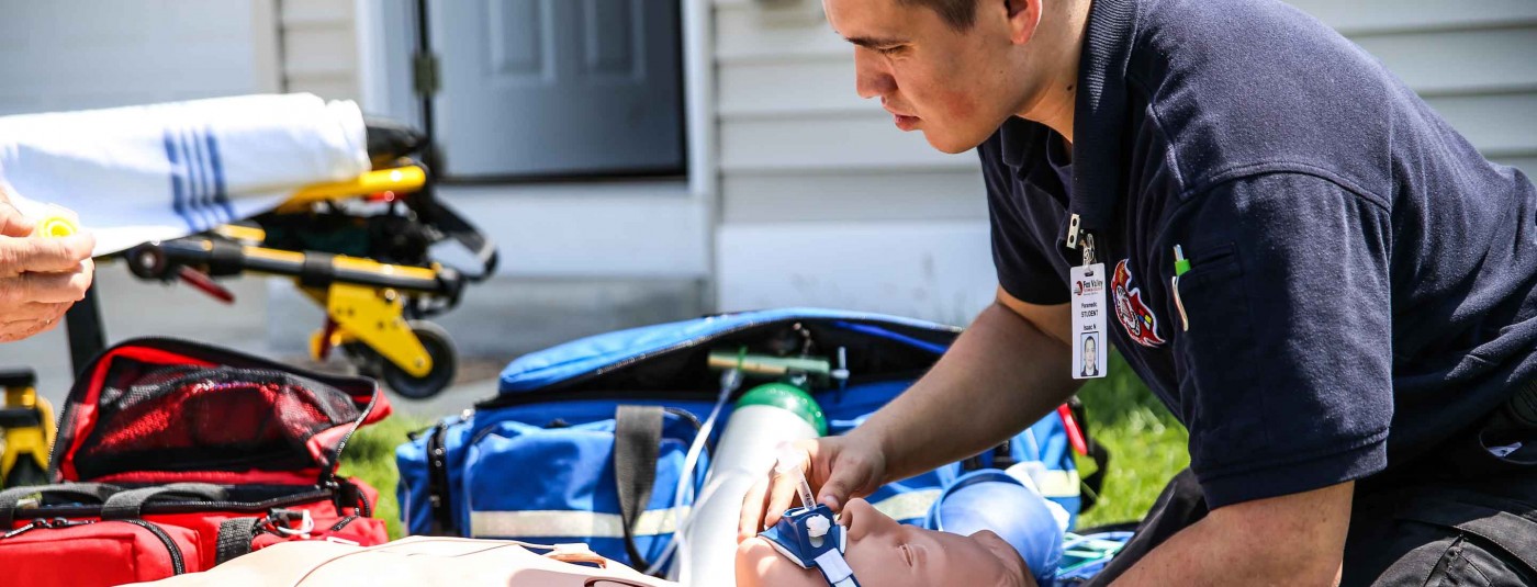 EMT student practicing on mannequin 