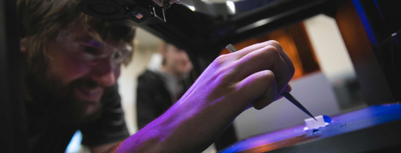 Northeast Wisconsin College student using 3D printer