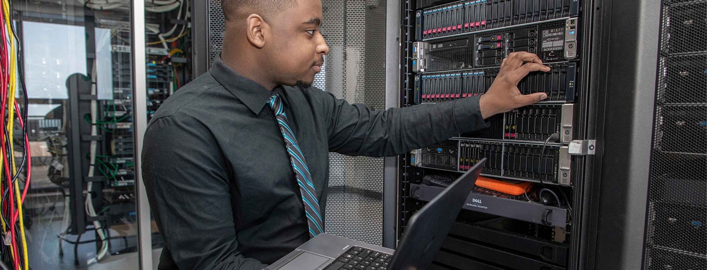 OEO Apprentice looking at server rack