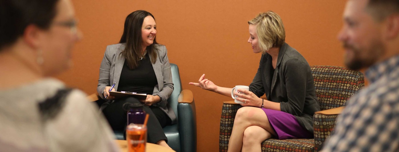 Two people chatting in office common area