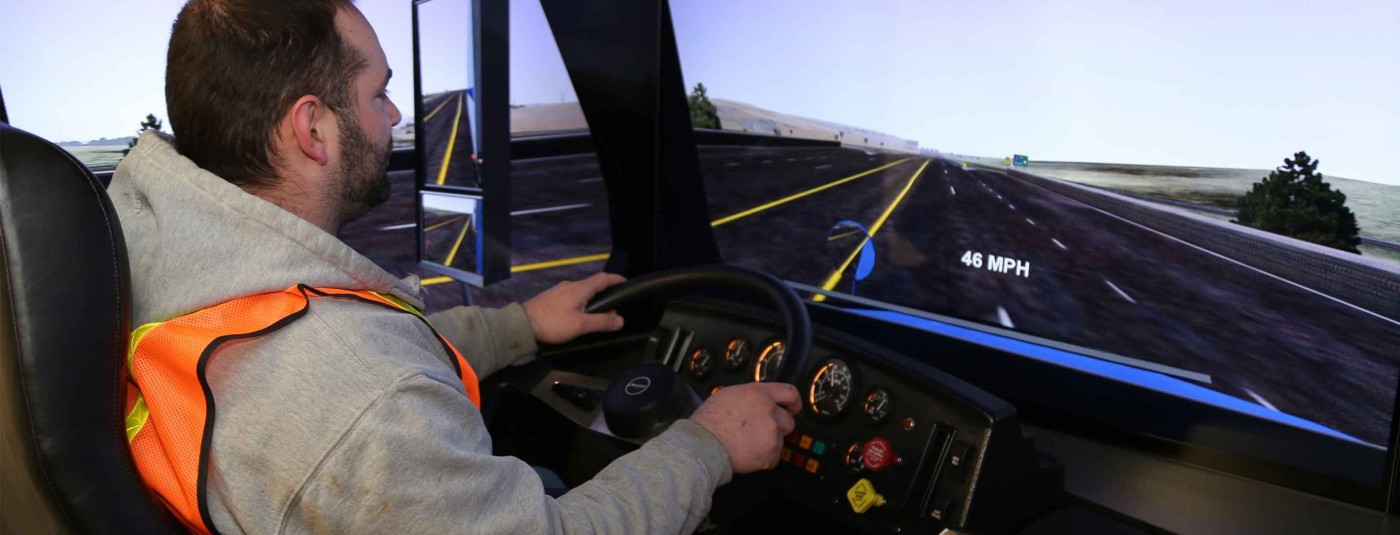 Student using truck driving simulator