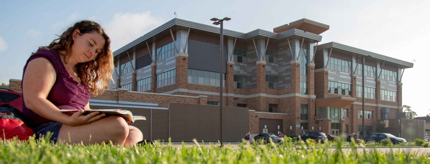 Western Tech College student sitting outside campus building