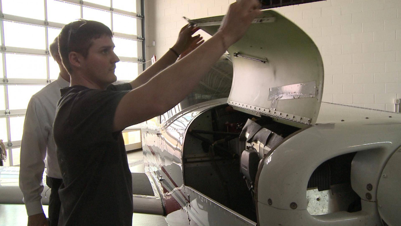 Student looking inside a plane