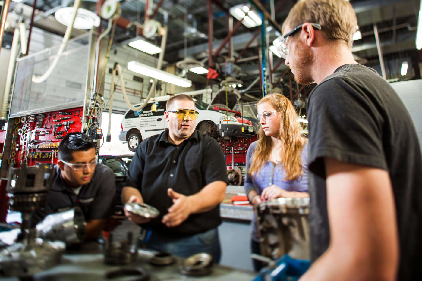 Class learning about auto mechanics