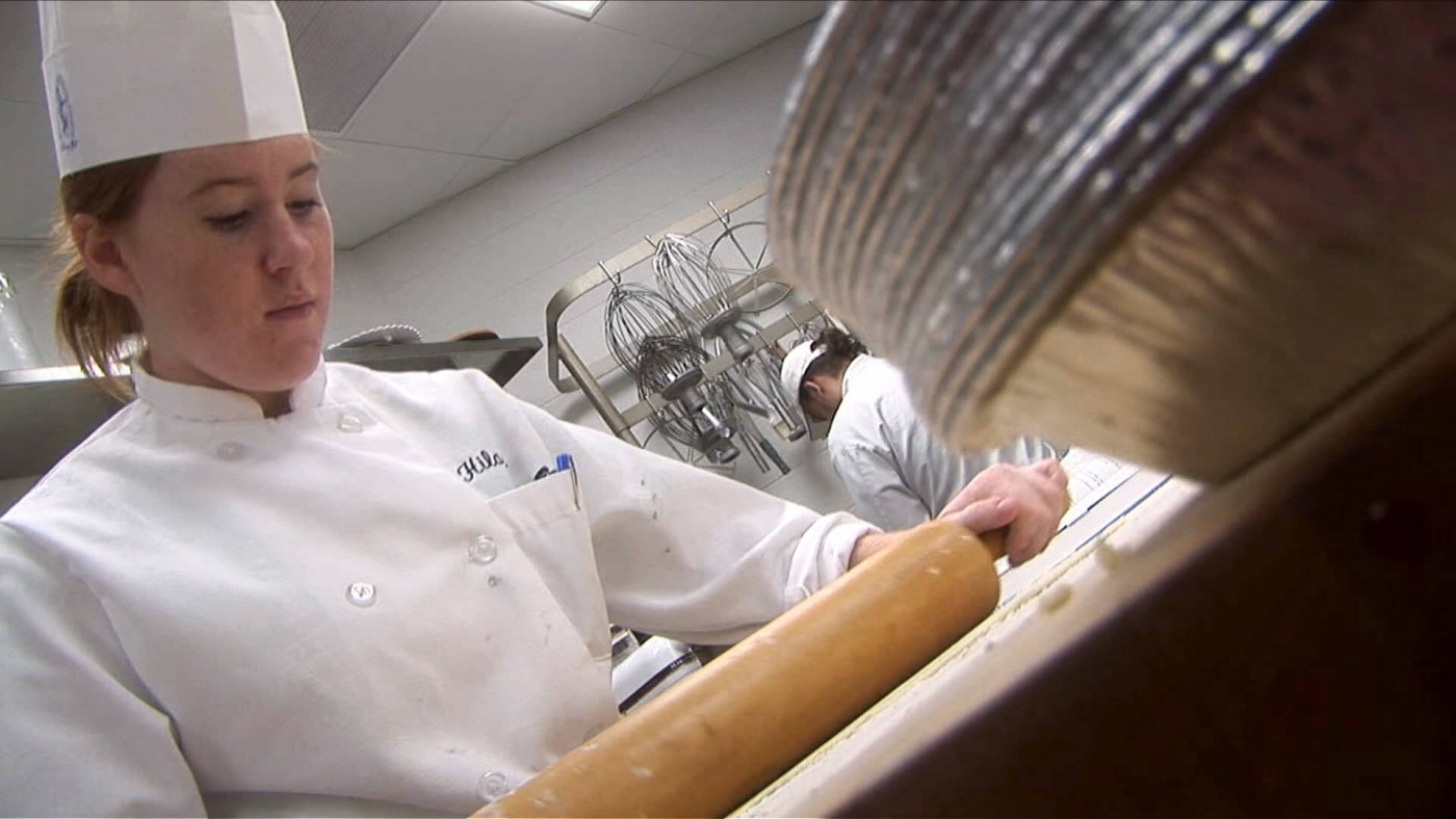 baker rolling dough