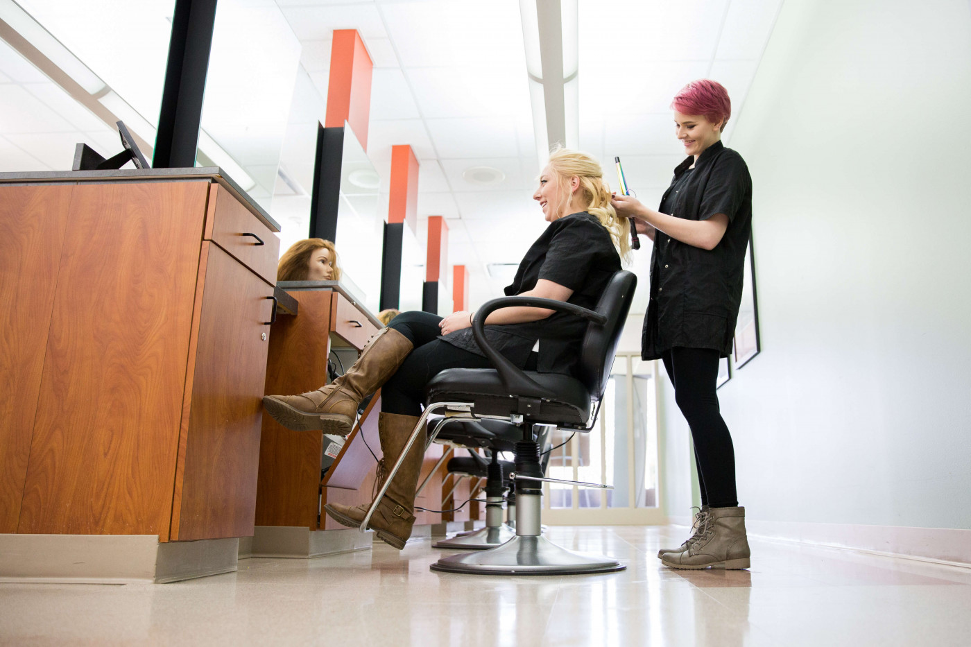 cosmetology student working on a hairstyle