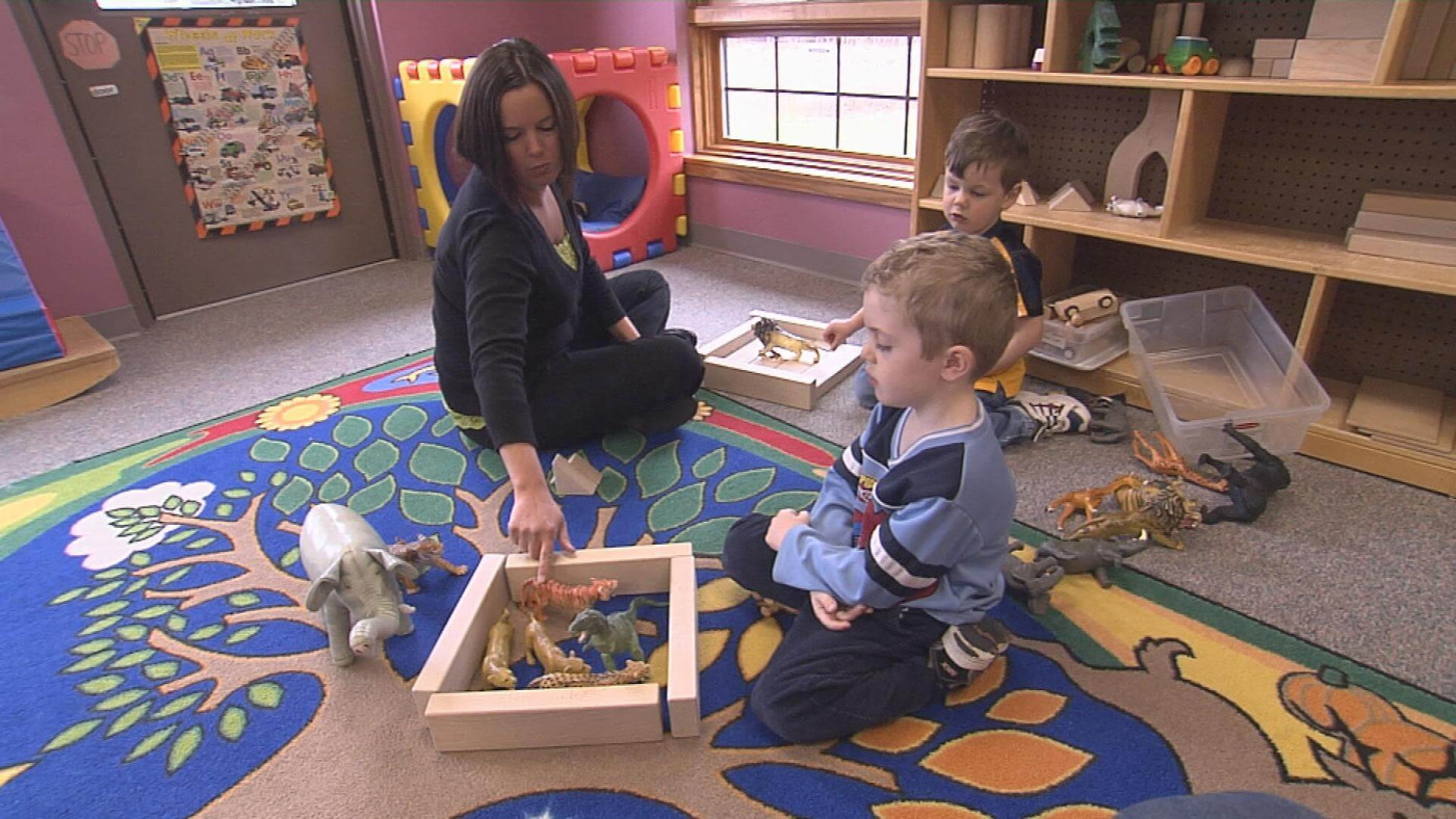 Teacher working with young students