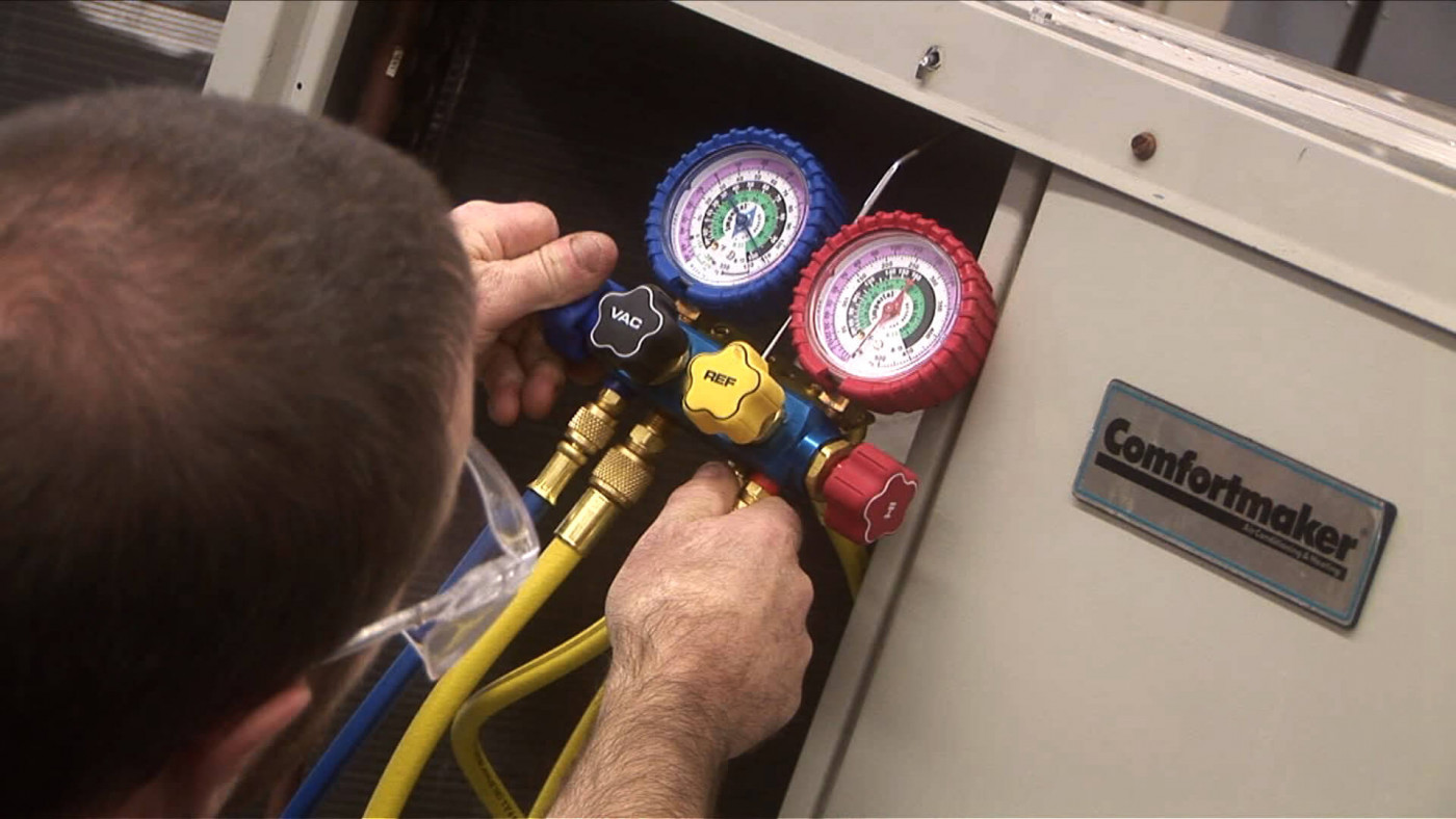 Working on an air conditioning unit