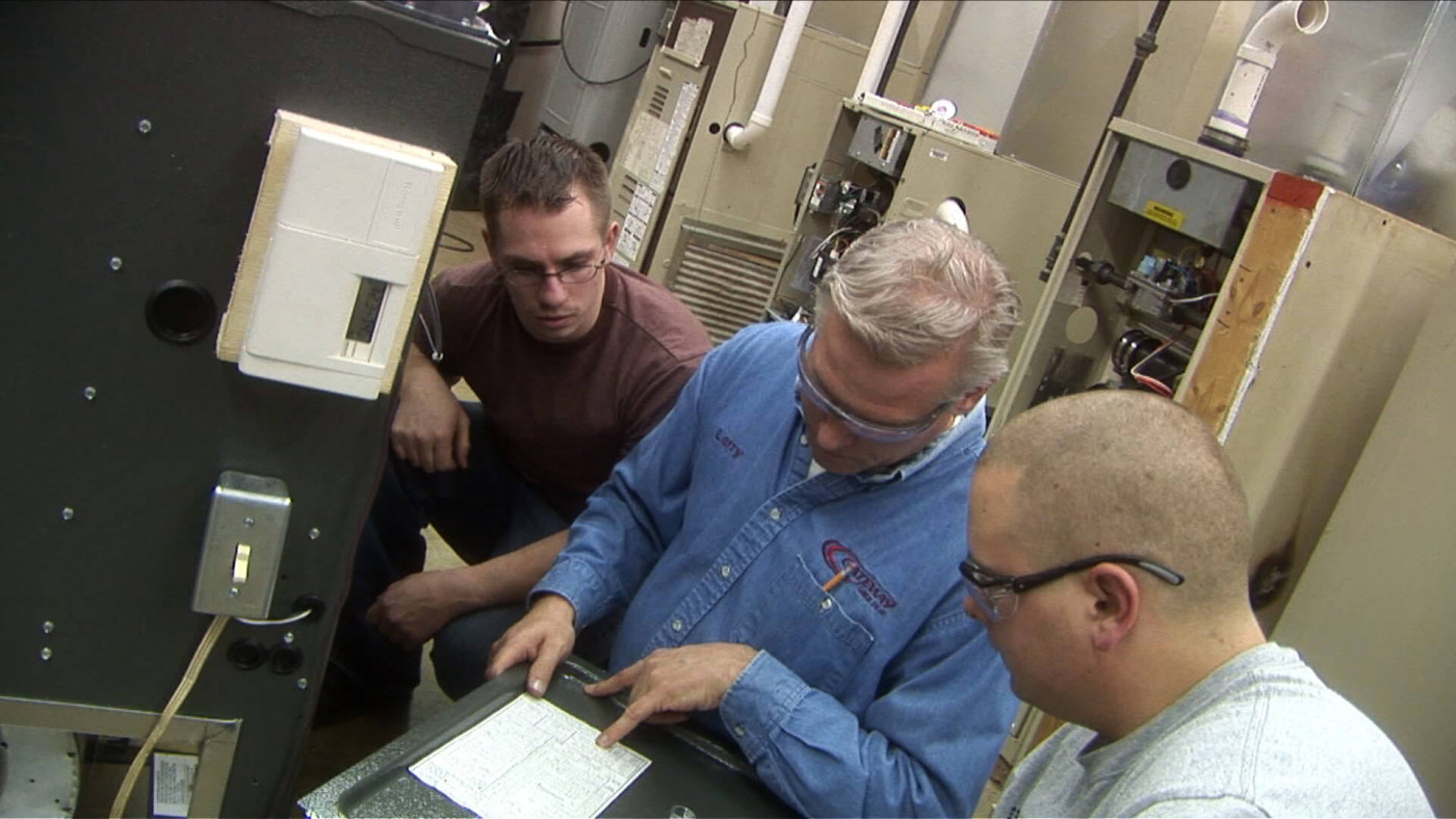 HVAC students looking at equipment