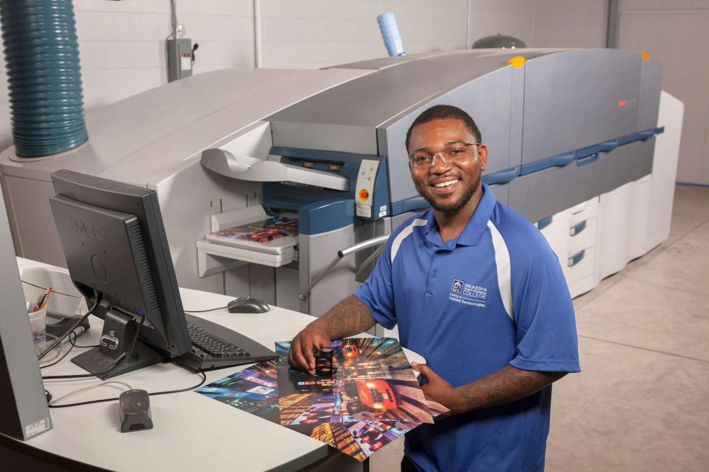 Man in printing lab examining a proof