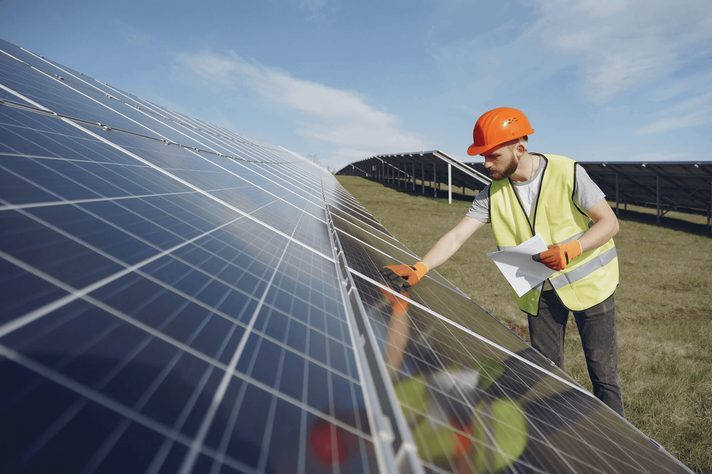 worker inspecting a solar array